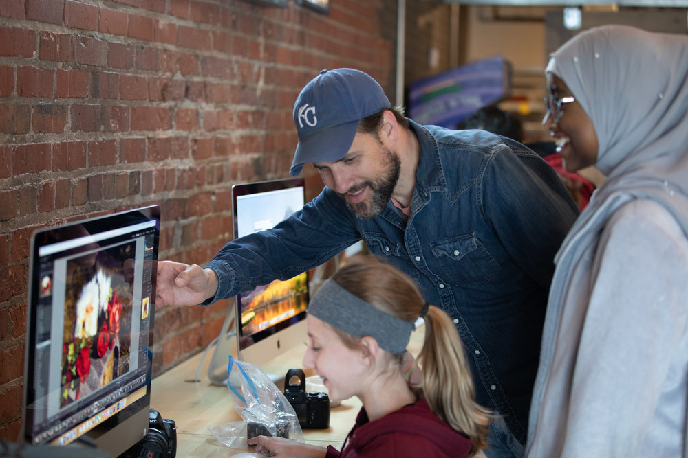 students on a computer with their teacher