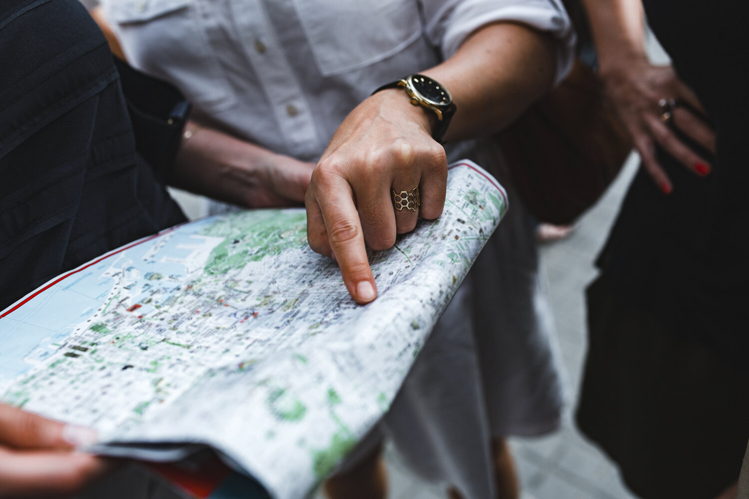 people pointing at a paper map