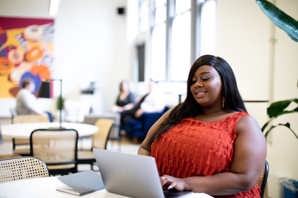 person on a laptop in an open work space