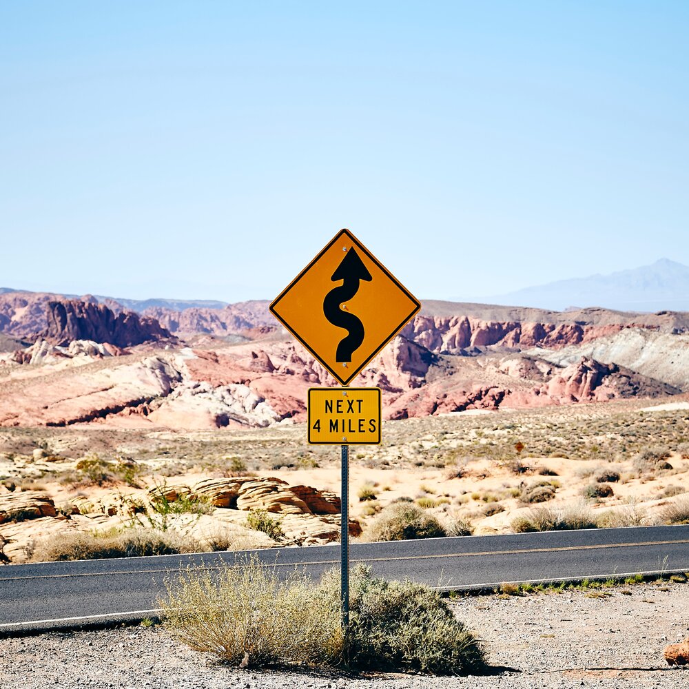 Next 4 Miles winding road sign for canyon road