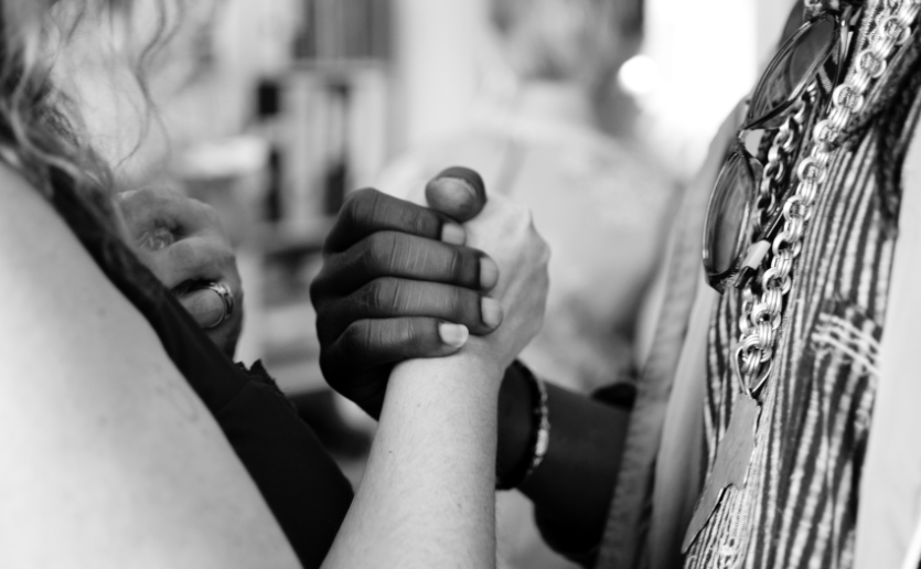 people clasping hands