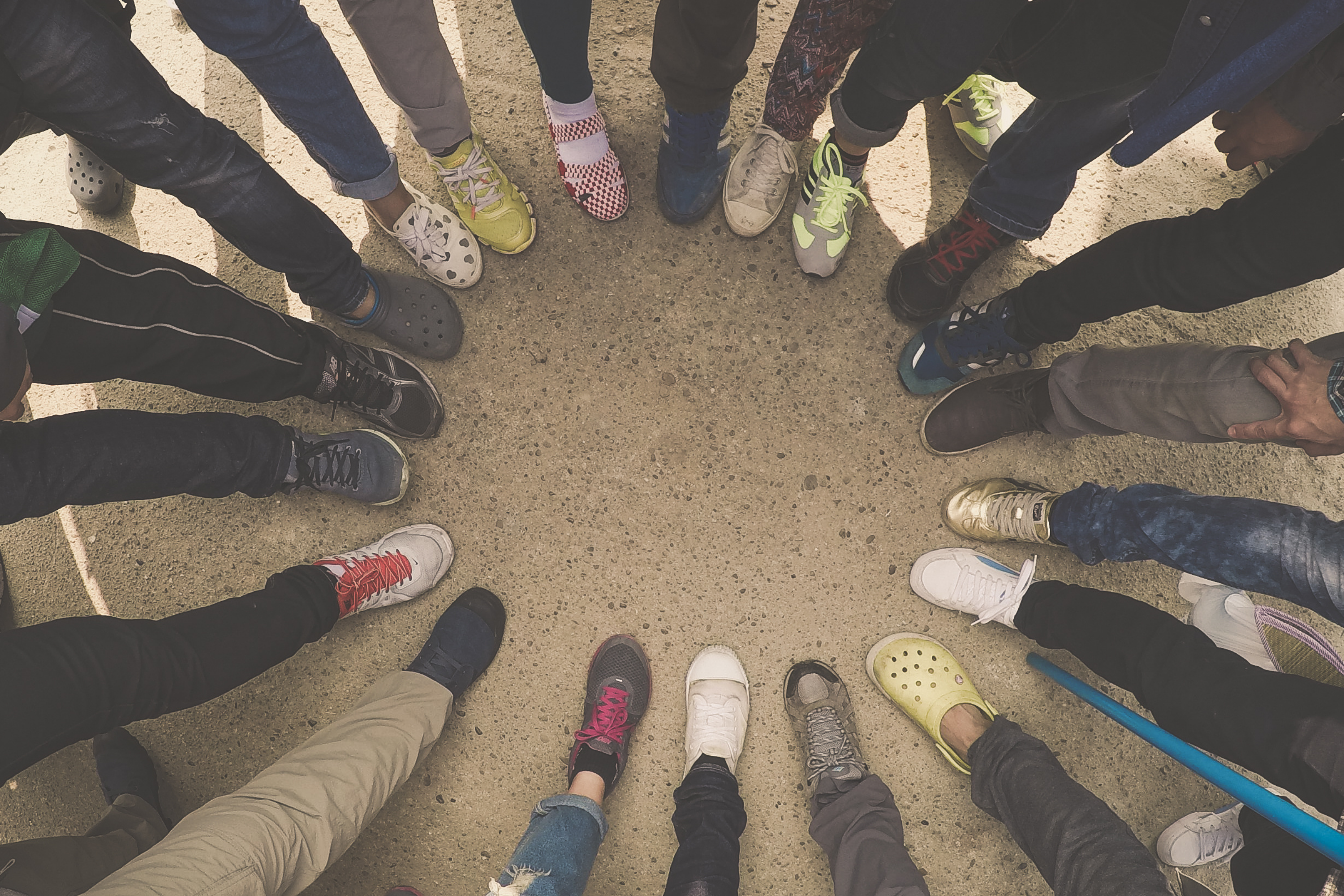 people forming a circle with their feet