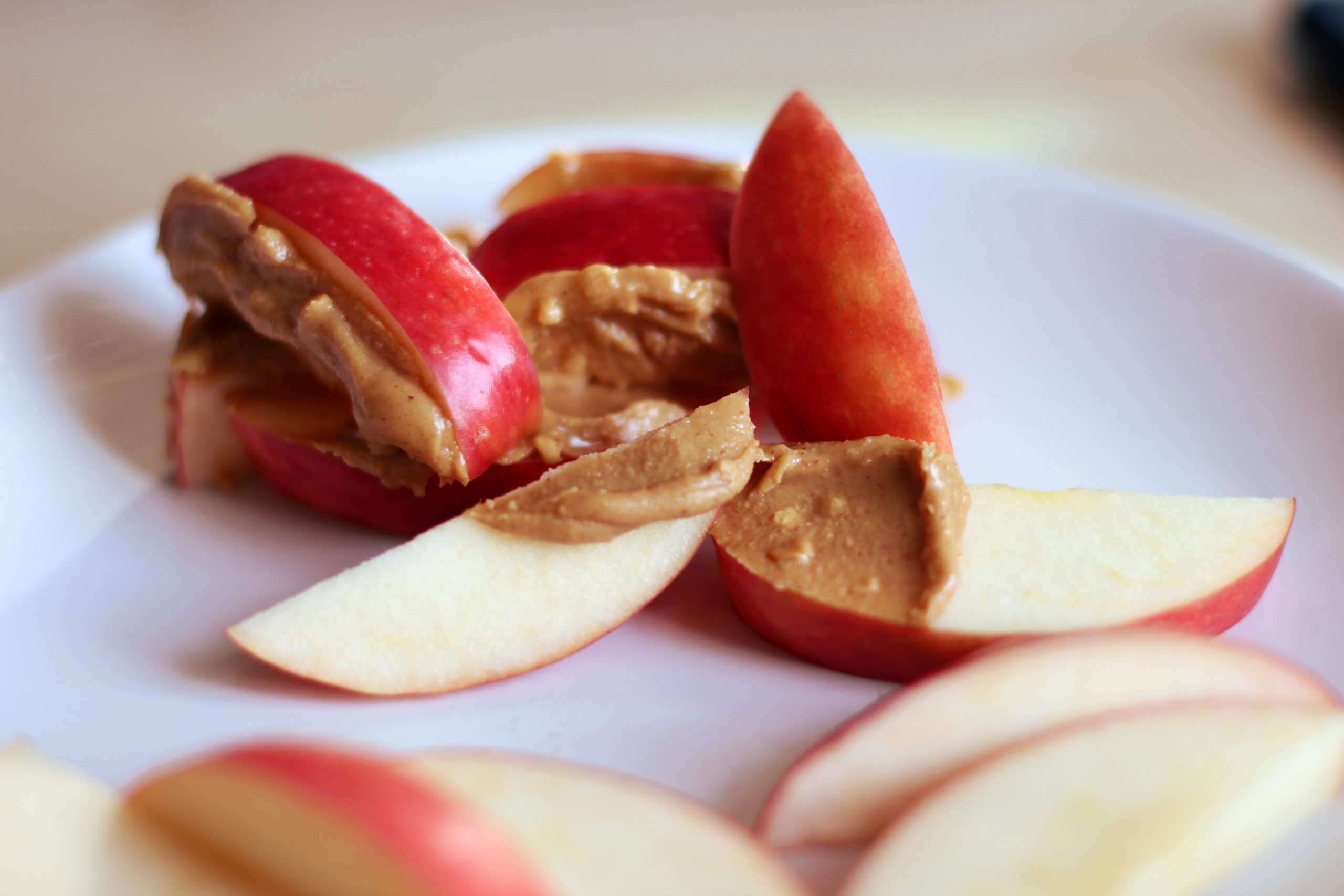 plate with sliced apples and peanut butter